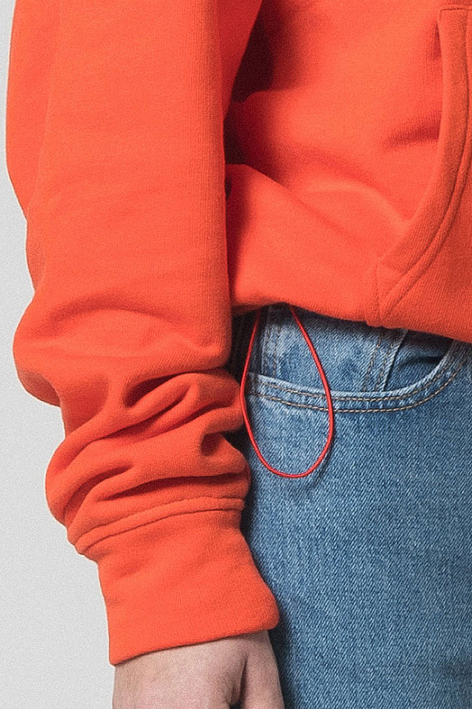 Orange cotton hoodie with adjustable length.