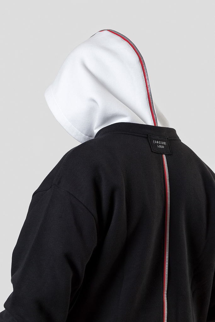 Designer hoodie and sweatshirt in black with white hood. Made of recycled PET bottles from the ocean and organic cotton. This hoodie has an exchangeable hood, adjustable length, reflective tape and embroidery. 