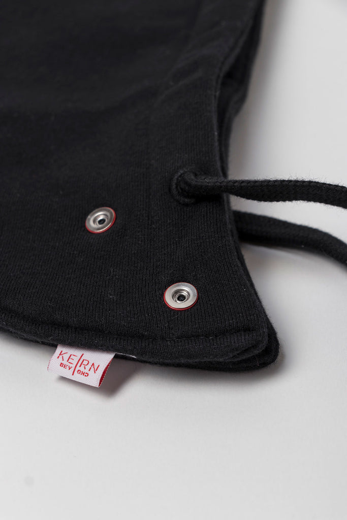 Close-up black exchangeable hood with buttons and logo. 