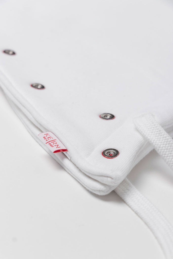Close-up white exchangeable hood with buttons and logo. 